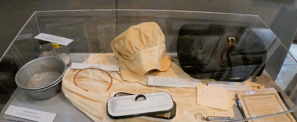 Discovering Powerful, Enduring Legacies of Juneteenth on the Gullah Trail 2 A doctor's bag, nurses' outfit, glasses in a display case.