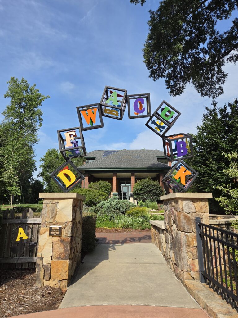 Greensboro: Big, Unexpected Adventures From 1781 Battlefield to Jeansboro 8 Arched entry into the Children's Garden topped with large wire, colorful alphabet blocks.