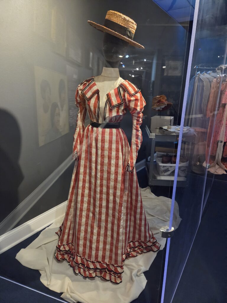 A long plaid dress in display case