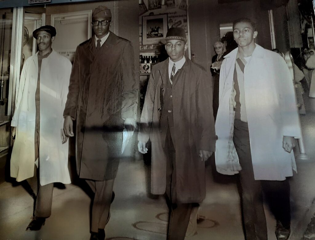 Greensboro: Big, Unexpected Adventures From 1781 Battlefield to Jeansboro 29 Four-four young black men, college freshmen at A&T in Greensboro, walking out of Woolworth's at the end of the day.