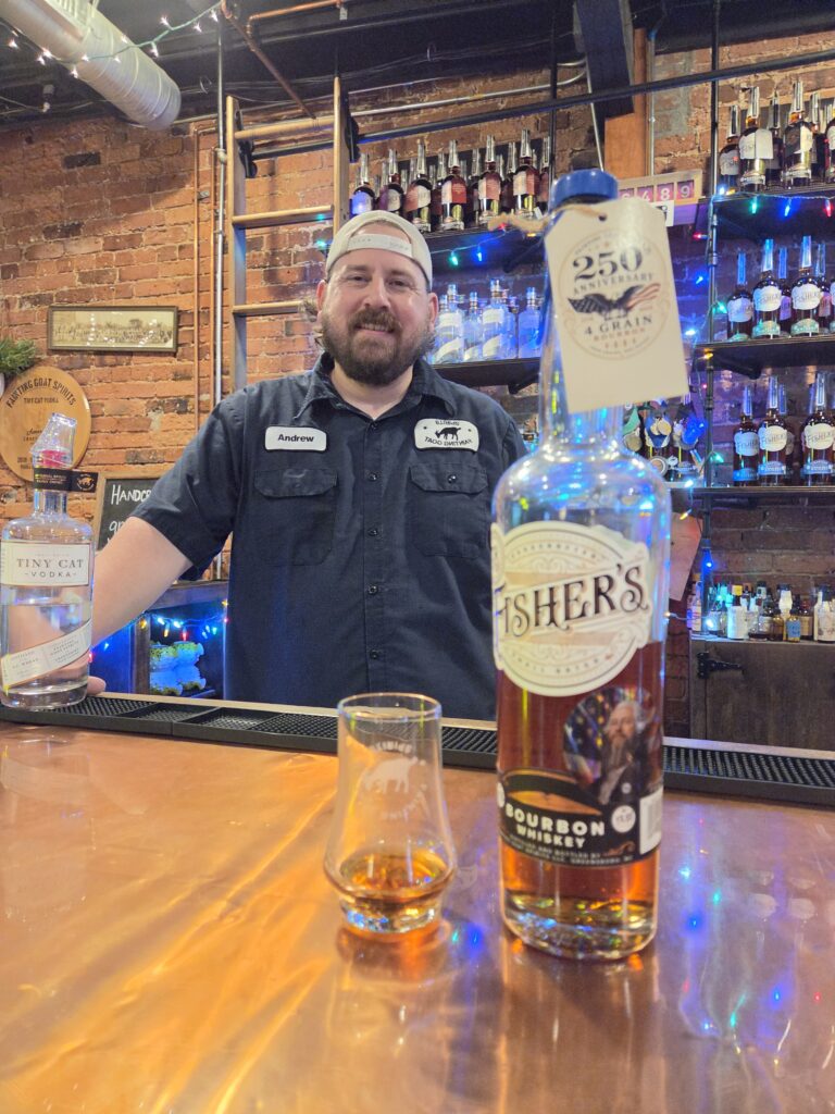 Greensboro: Big, Unexpected Adventures From 1781 Battlefield to Jeansboro 48 Fisher's limited edition bottle for America's Birthday and the distiller behind the bar.