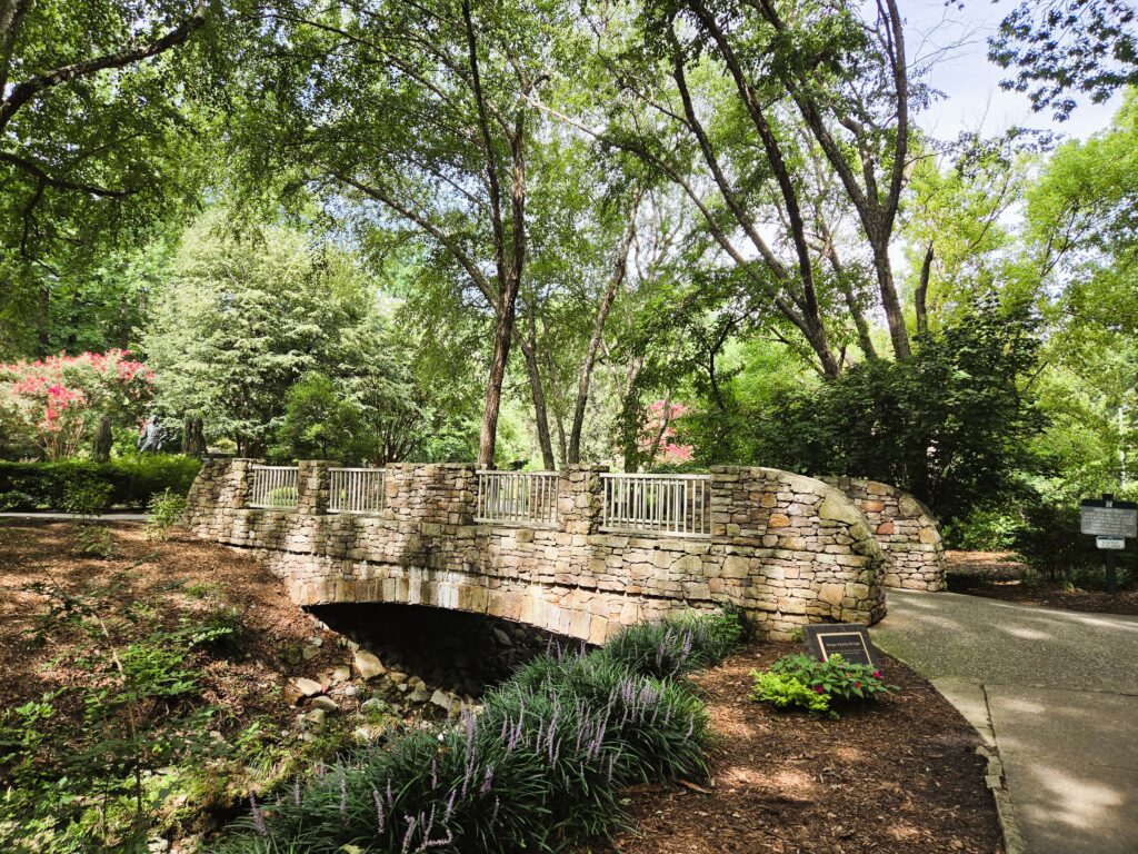 A stone bridge over a stream in the garden.
