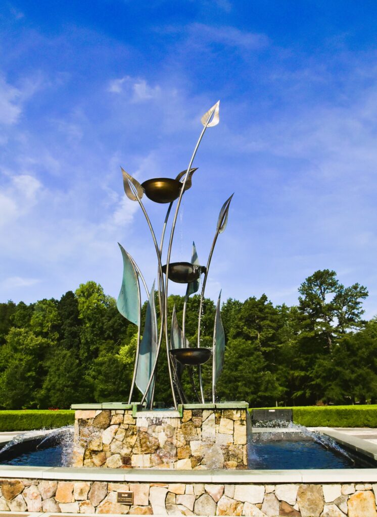 Greensboro: Big, Unexpected Adventures From 1781 Battlefield to Jeansboro 1 A tall metal sculpture of leaves and spilling water into a fountain in Greensboro's Gateway Gardens.