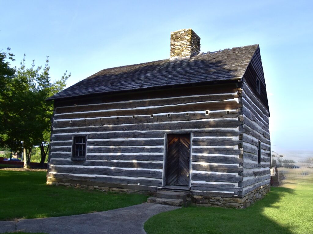 A historic log house that was moved and preserved.