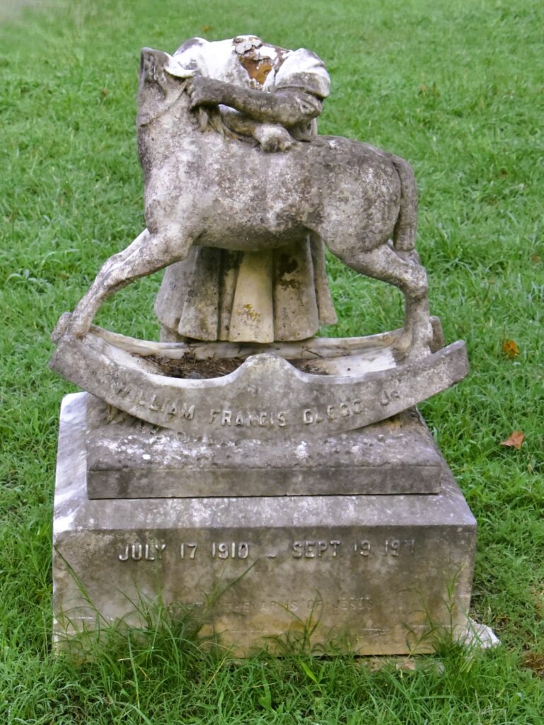 Greensboro: Big, Unexpected Adventures From 1781 Battlefield to Jeansboro 12 A broken headstone, which apparently was a child standing with arms around the neck of a rocking horse.